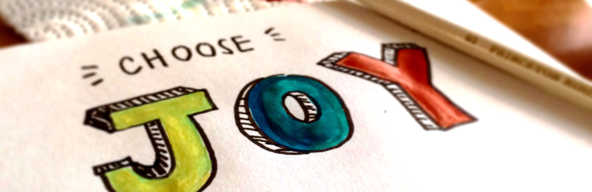 Papper med målad text "Choose Joy"